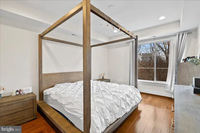 a bedroom with a bed and a dresser