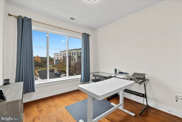 a view of a bedroom with furniture and wooden floor