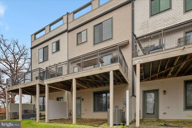 a view of a roof deck with couches and wooden floor