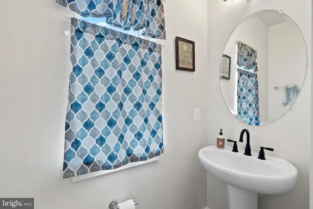 a bathroom with a sink a mirror and a toilet