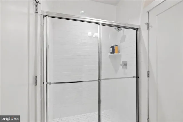 a bathroom with a glass shower door