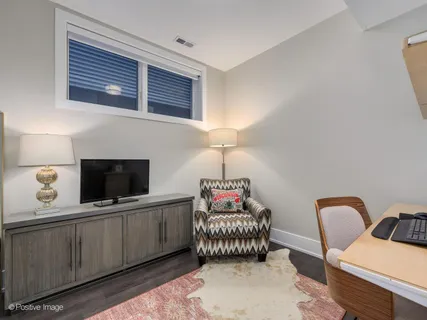 a bedroom with furniture and a flat screen tv