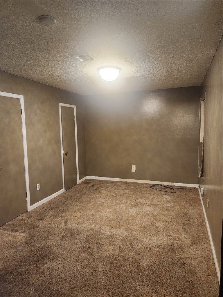 1202 Washington Street Tuskegee Institute, AL 36088 - Photo 3 of 7 This interior space features durable carpeting and essential safety elements, offering a functional and secure environment.