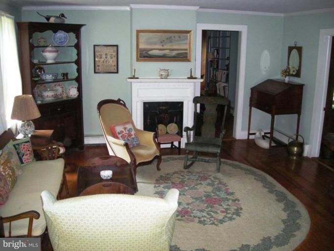 6329 Bozman Neavitt Road Neavitt, MD 21652 - Photo 5 of 19 Living room with original floors and mantle