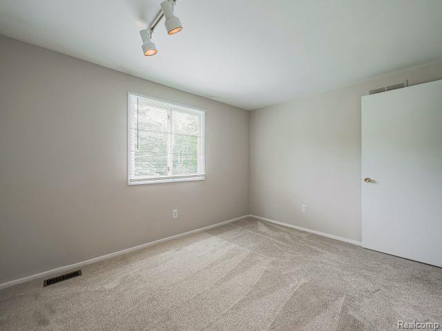 21728 Ruth Street Farmington, MI 48336 - Photo 42 of 54 Room with light grey carpeting and neutral wall paint