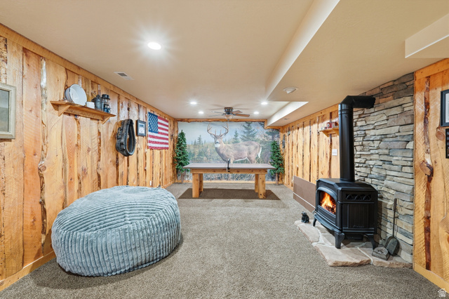 2420 West Old Hwy Road Morgan, UT 84050 - Photo 27 of 54 Playroom featuring wooden walls, recessed lighting, a gas stove, ceiling fan, and carpet