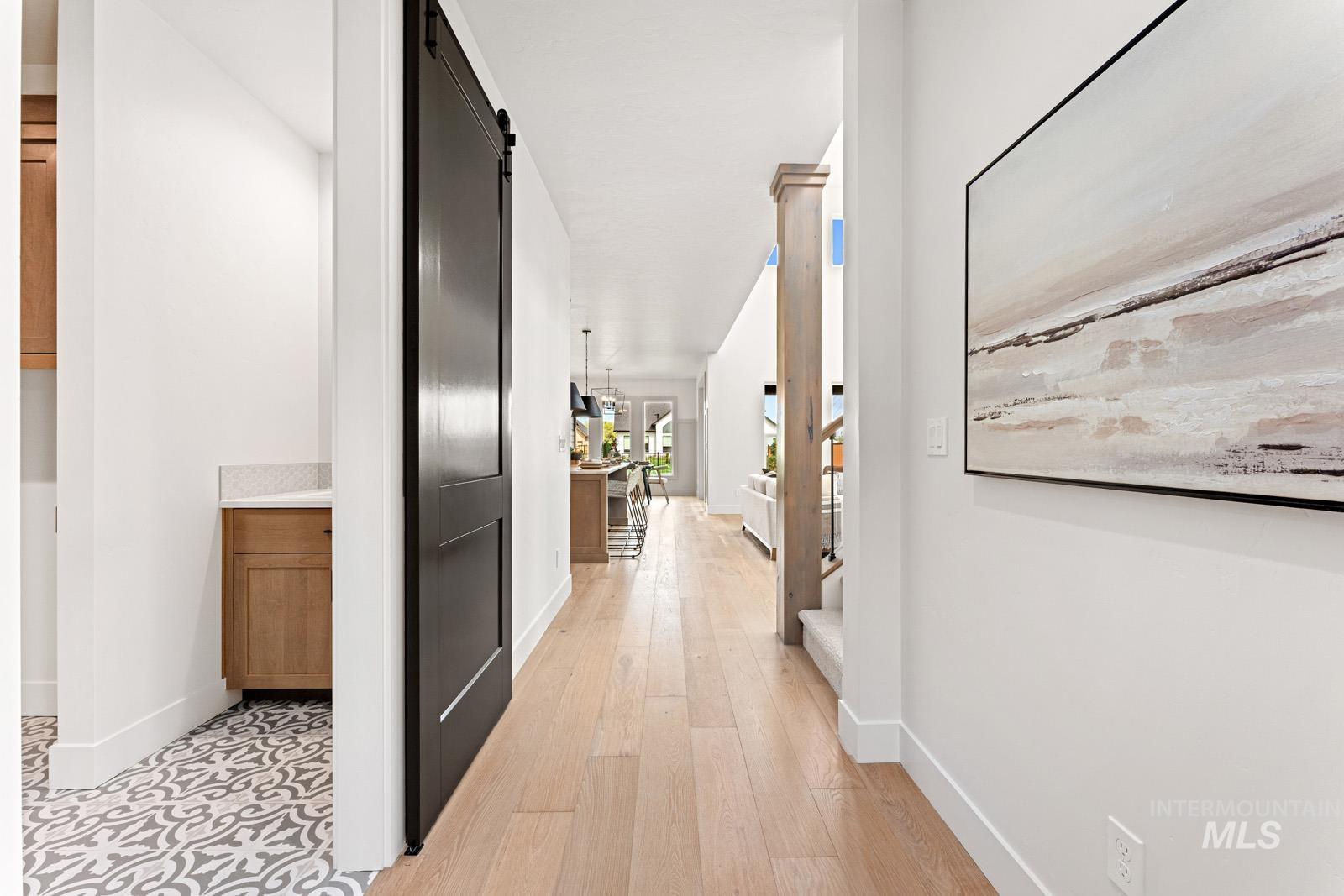 6792 Saddle Bred Way Star, ID 83669 - Photo 13 of 50 Hallway featuring a barn door and light wood-style flooring