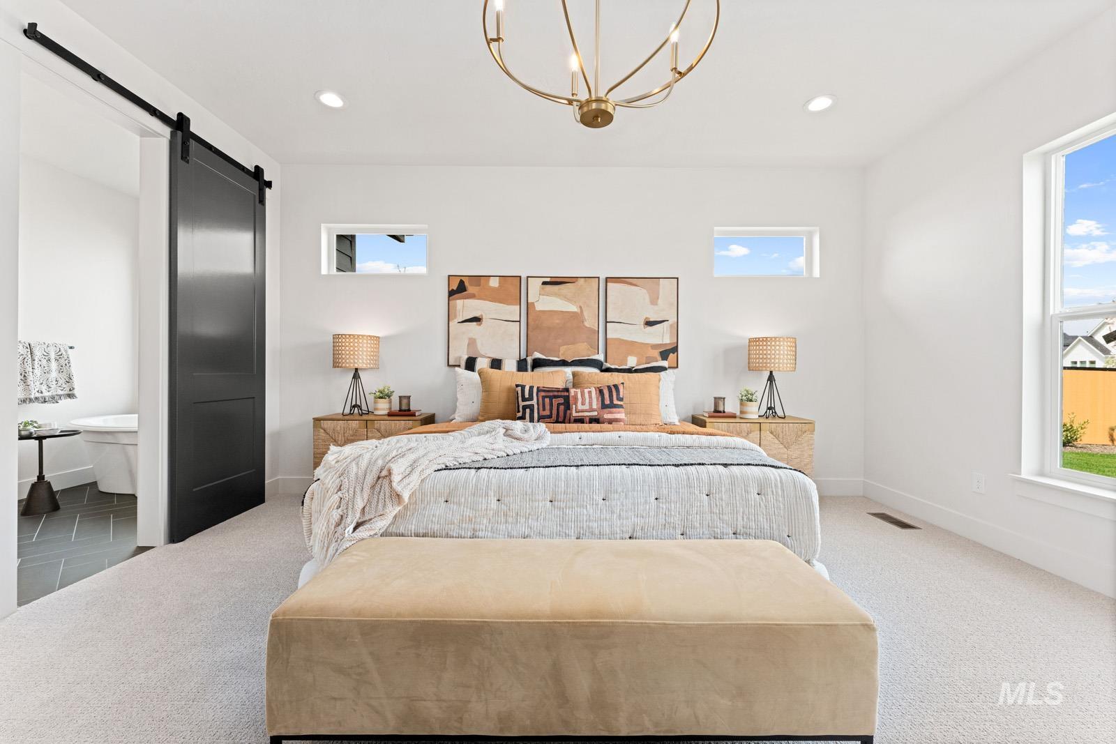 6792 Saddle Bred Way Star, ID 83669 - Photo 17 of 50 Bedroom featuring a barn door, carpet, suspended lighting, and multiple windows