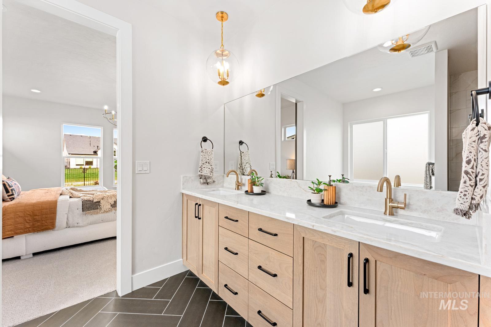6792 Saddle Bred Way Star, ID 83669 - Photo 18 of 50 Ensuite bathroom featuring double vanity, recessed lighting, and dark tile patterned flooring