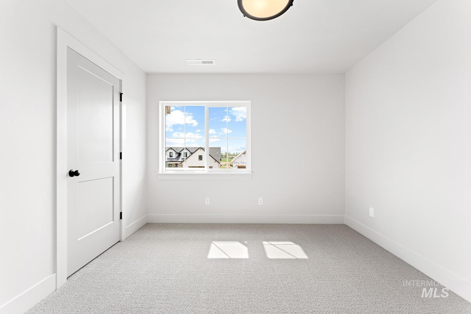 6792 Saddle Bred Way Star, ID 83669 - Photo 26 of 50 Unfurnished bedroom with light carpet and baseboards
