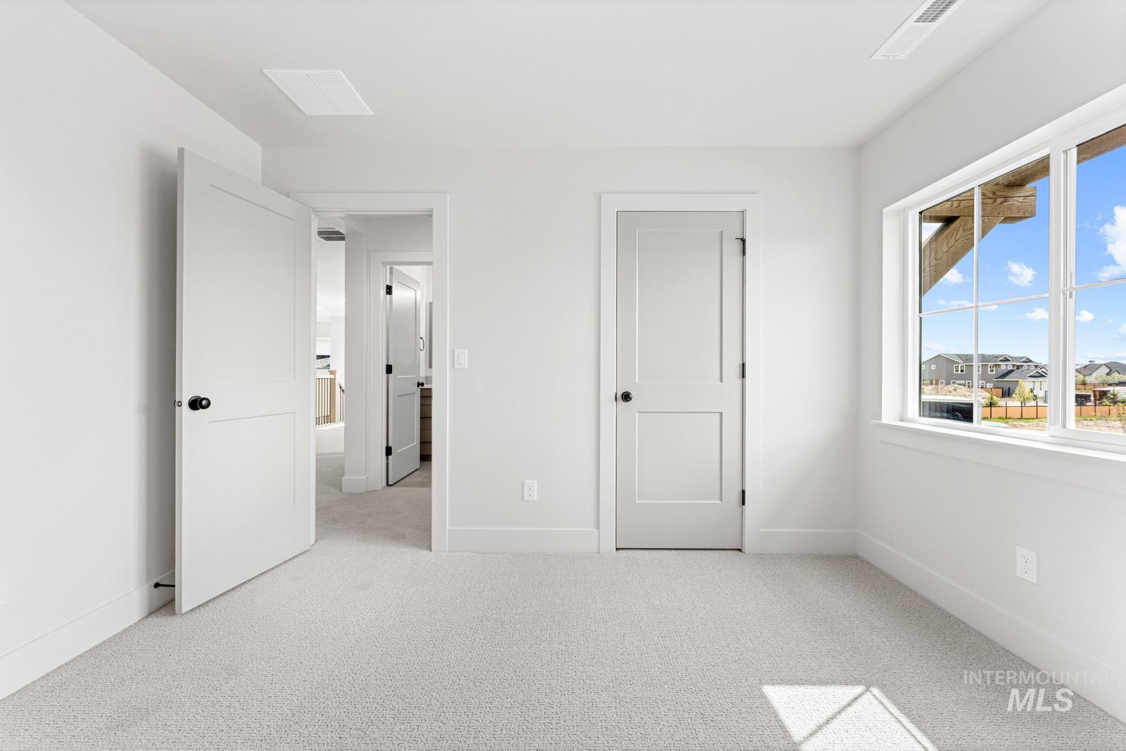 6792 Saddle Bred Way Star, ID 83669 - Photo 28 of 50 Unfurnished bedroom featuring light colored carpet and baseboards