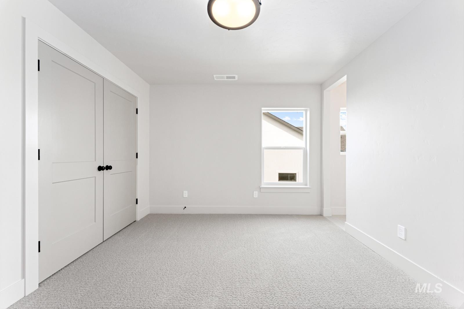 6792 Saddle Bred Way Star, ID 83669 - Photo 30 of 50 Unfurnished bedroom with light carpet and a closet