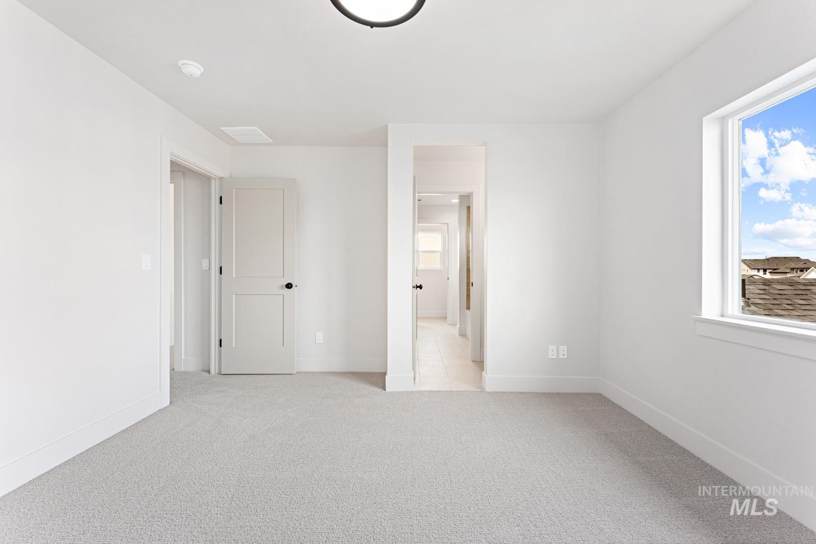 6792 Saddle Bred Way Star, ID 83669 - Photo 31 of 50 Unfurnished bedroom with light carpet and ensuite bathroom