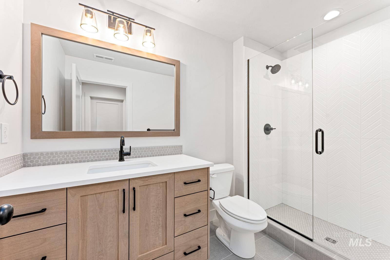 6792 Saddle Bred Way Star, ID 83669 - Photo 32 of 50 Full bathroom featuring vanity, a stall shower, and light tile patterned floors