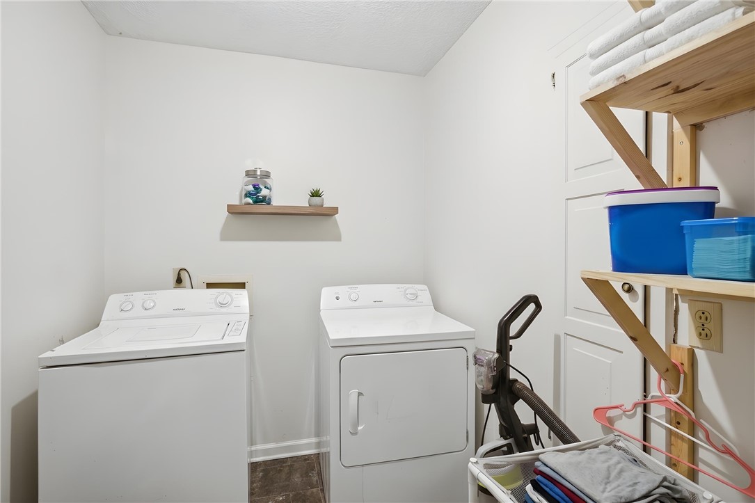 311 Cumberland Way Anderson, SC 29621 - Photo 33 of 44 Functional laundry room equipped with washer, dryer, and built-in shelving for optimal organization.