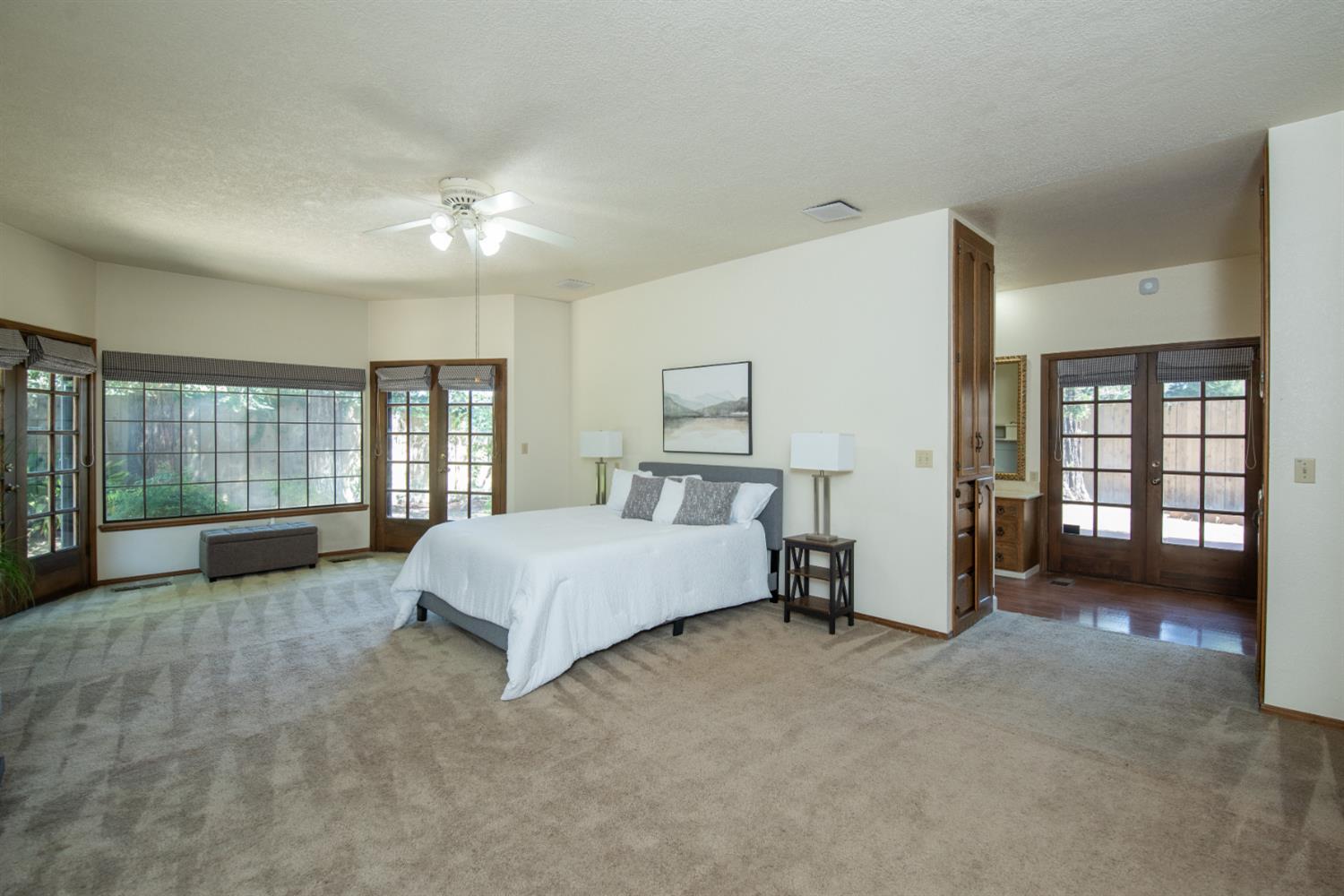 925 Scenic Court Modesto, CA 95355 - Photo 32 of 62 a spacious bedroom with a bed a couch and large window