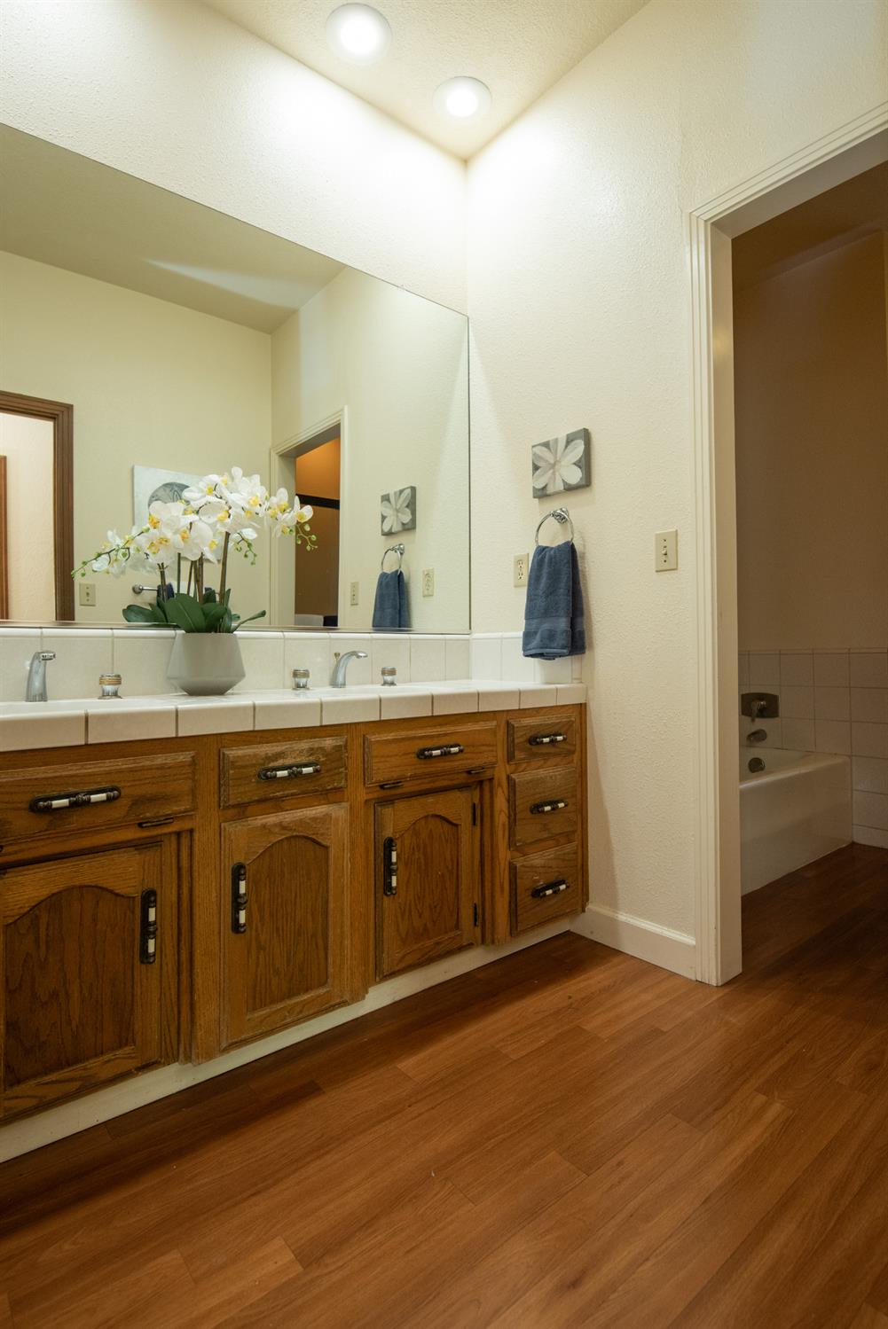 925 Scenic Court Modesto, CA 95355 - Photo 52 of 62 a spacious bathroom with a granite countertop sink and a mirror
