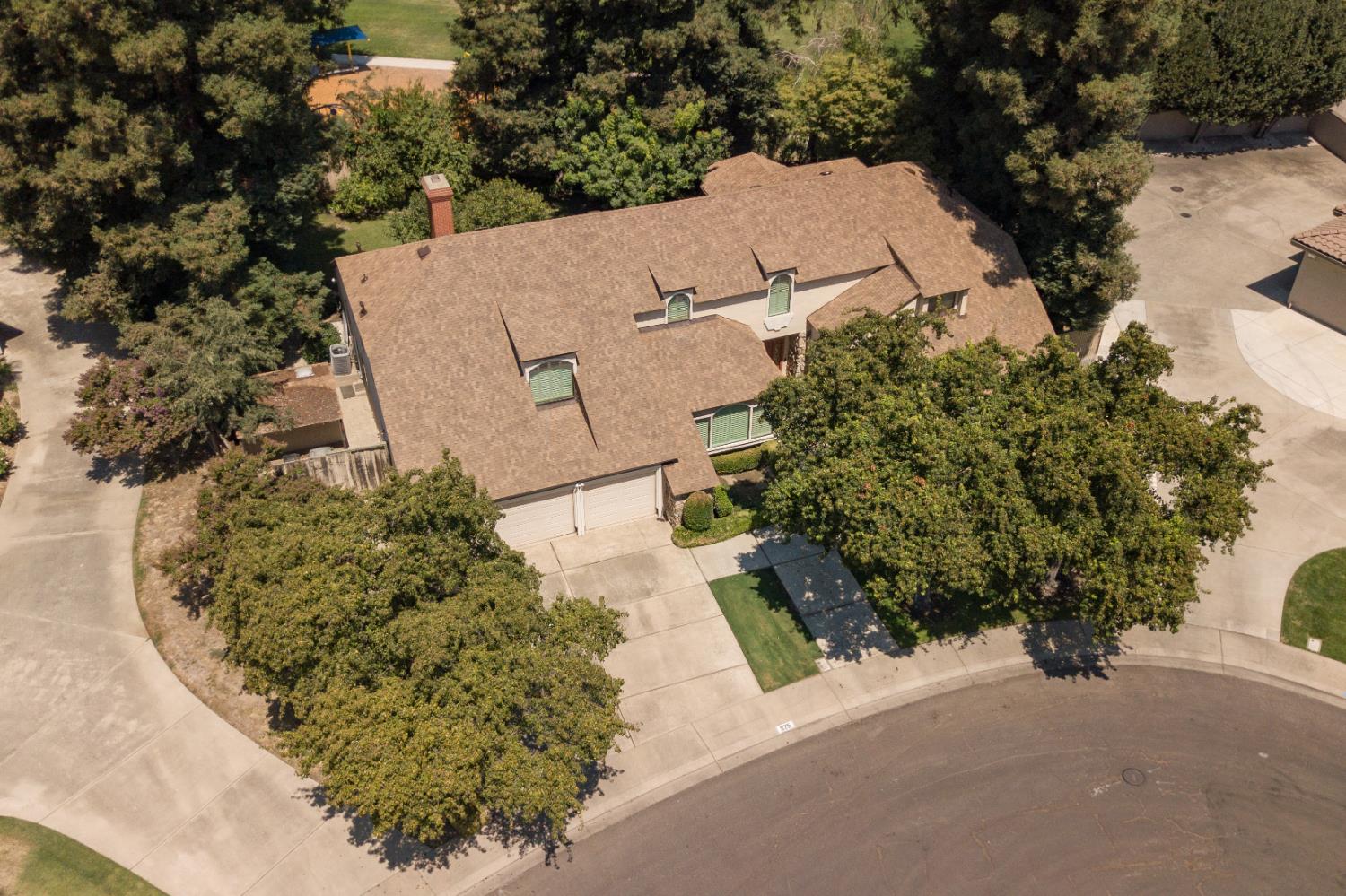 925 Scenic Court Modesto, CA 95355 - Photo 61 of 62 an aerial view of a house with a yard and trees