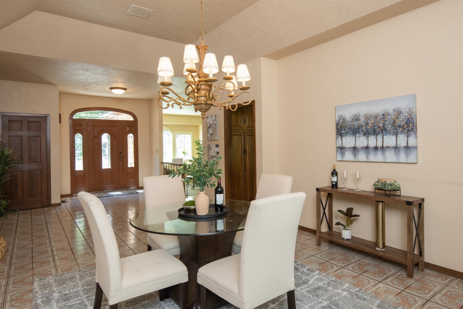 925 Scenic Court Modesto, CA 95355 - Photo 7 of 62 a view of a dining room with furniture a chandelier and wooden floor
