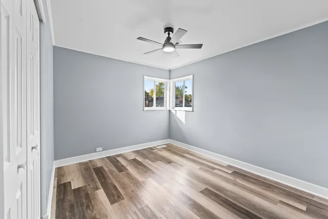 a view of room with window and ceiling fan
