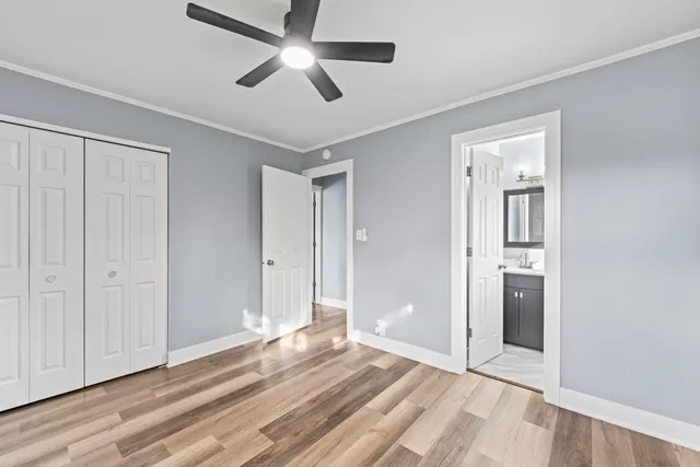 a view of an empty room with wooden floor