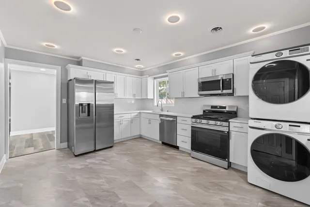 a kitchen with a refrigerator sink and stove top oven