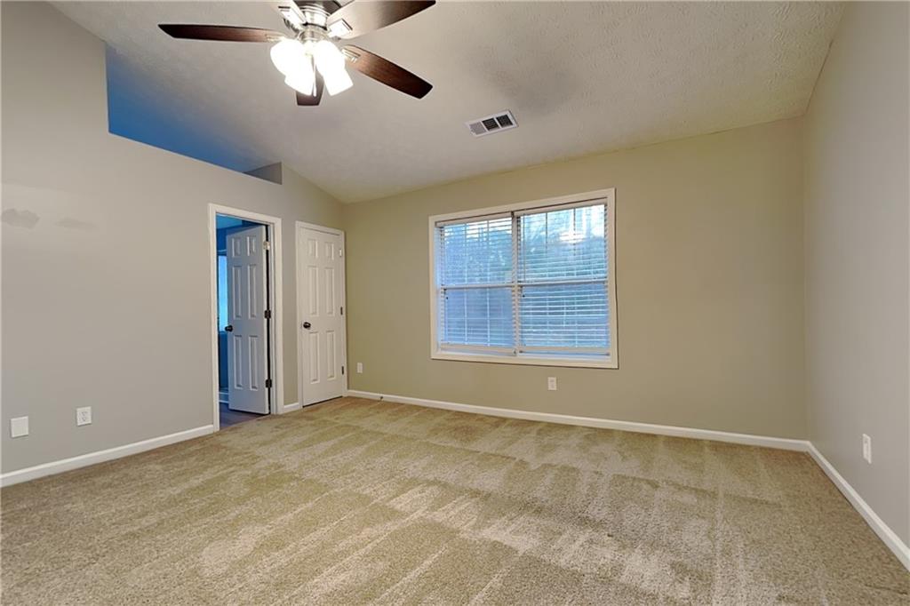 1664 Summit Pl Way Loganville, GA 30052 - Photo 11 of 23 a view of an empty room with window and chandelier fan