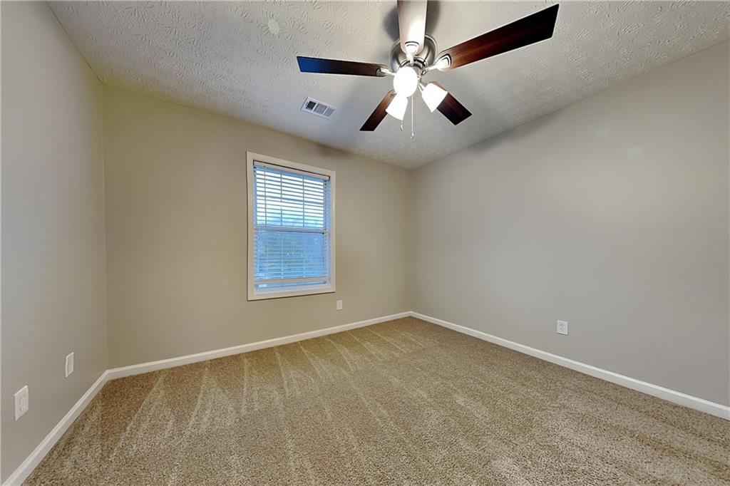 1664 Summit Pl Way Loganville, GA 30052 - Photo 17 of 23 wooden floor in an empty room with a window