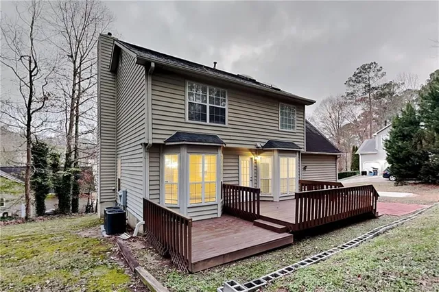 a front view of a house with balcony and wooden deck