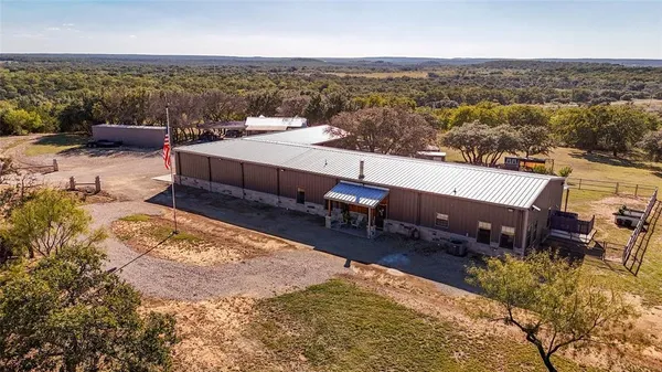 an aerial view of a house with a yard