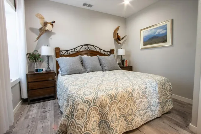 a bedroom with a bed and a chandelier