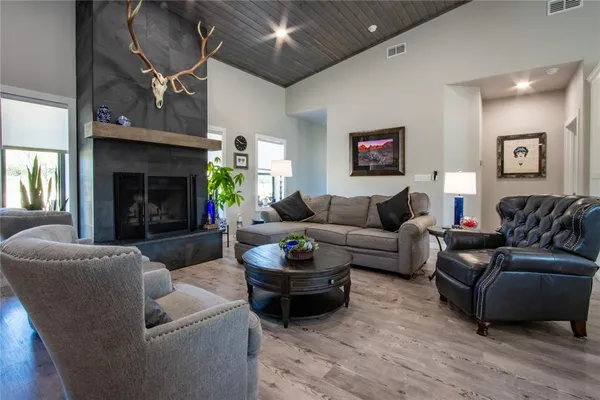 a living room with furniture a fireplace and a flat screen tv
