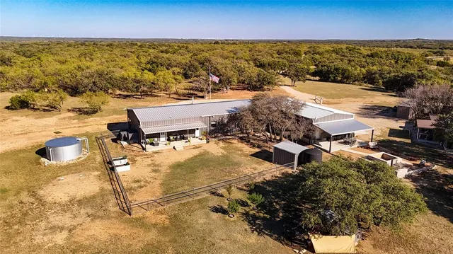 a view of a house with pool and sitting area