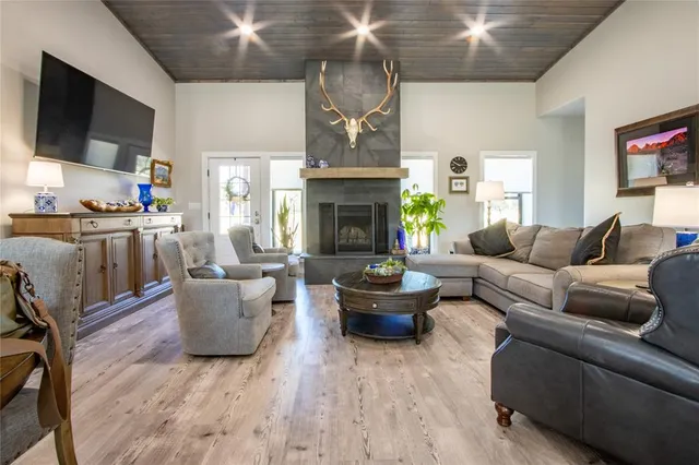 a living room with furniture a fireplace and a flat screen tv