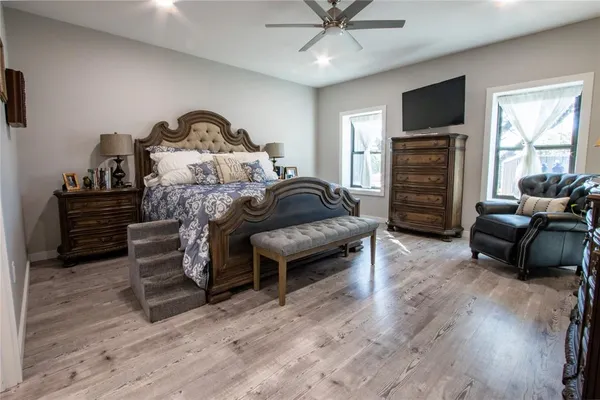 a bedroom with furniture and a flat screen tv