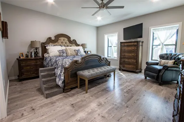 a bedroom with furniture and a flat screen tv