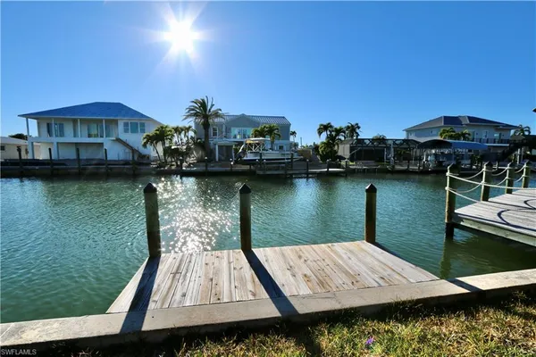 a view of a wooden deck and lake view