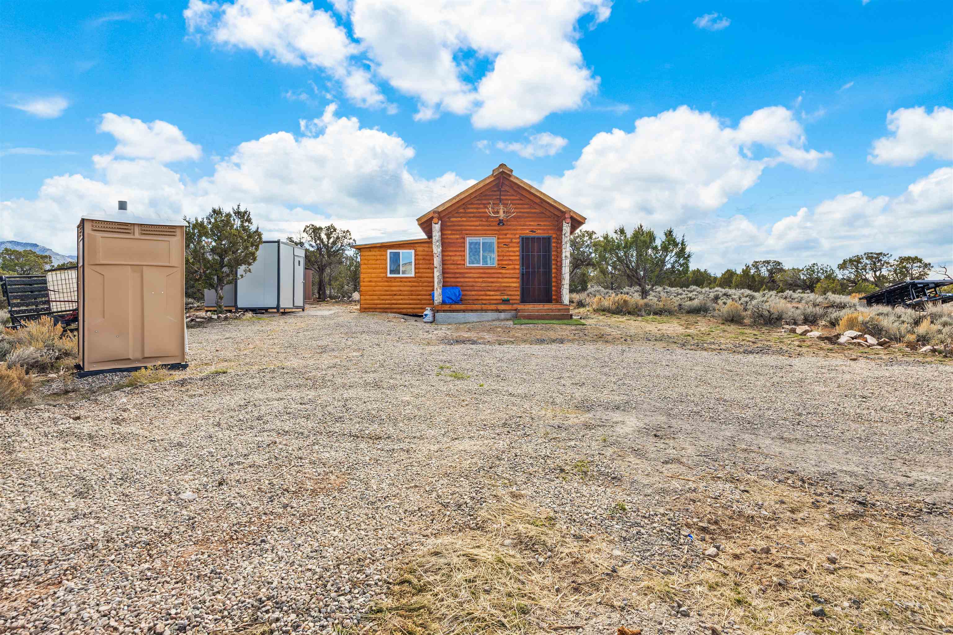 4193 V 5/10 Road De Beque, CO 81630 - Photo 18 of 39 a view of a house with a yard