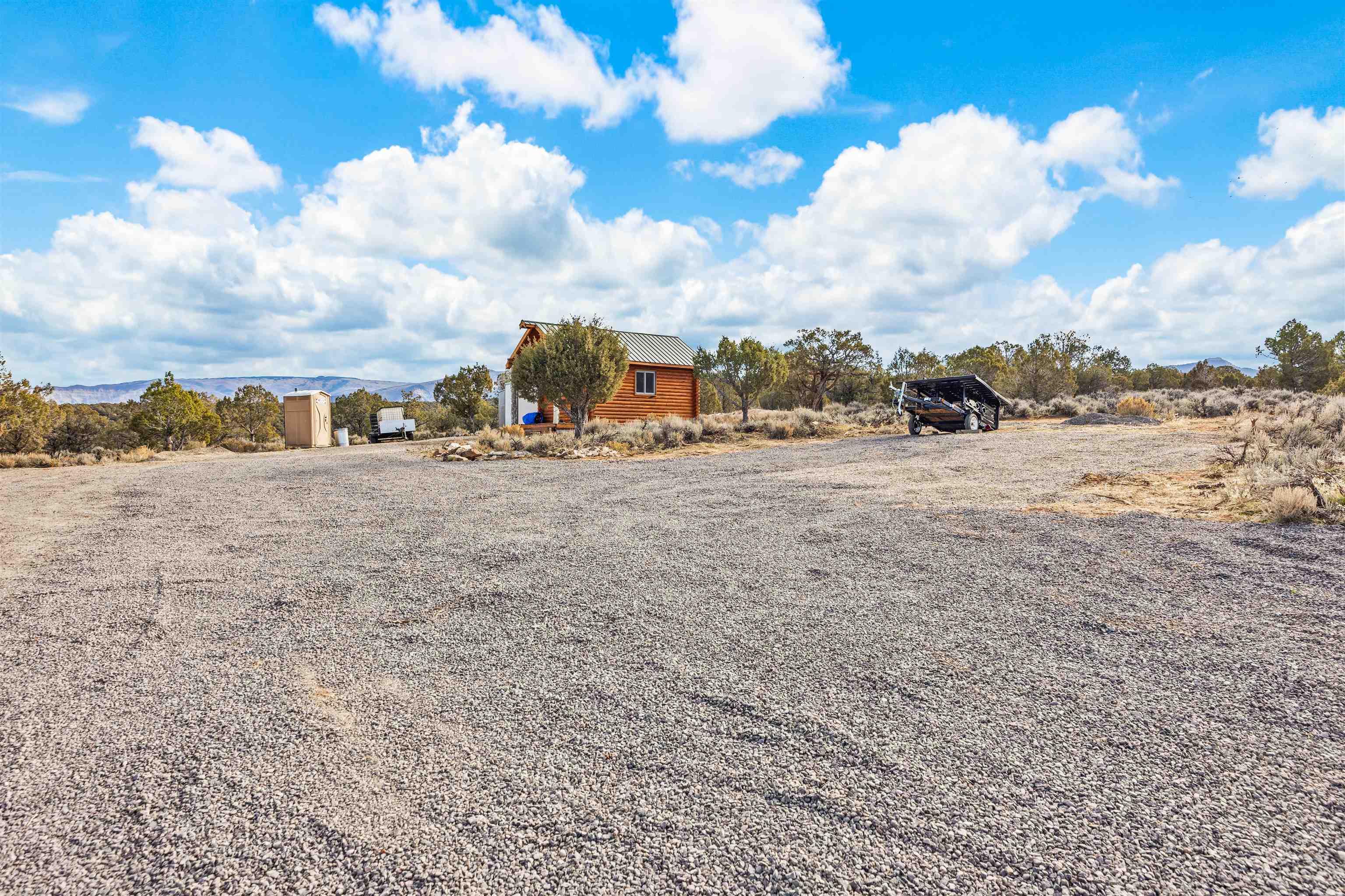 4193 V 5/10 Road De Beque, CO 81630 - Photo 3 of 39 a view of a dry yard with wooden fence