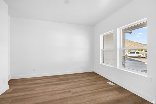 1510 West 600 North, Unit 4A Mapleton, UT 84664 - Photo 9 of 23 Empty room with wood finished floors and a mountain view