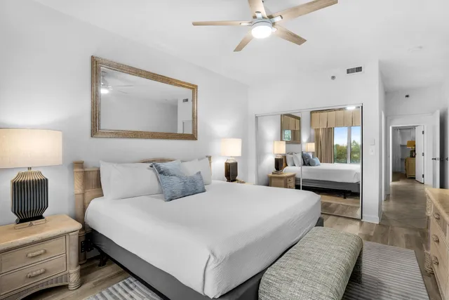 a bathroom with a granite countertop sink a large mirror and a shower