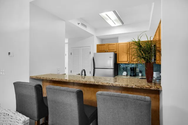 a living room with furniture a chandelier and a mirror