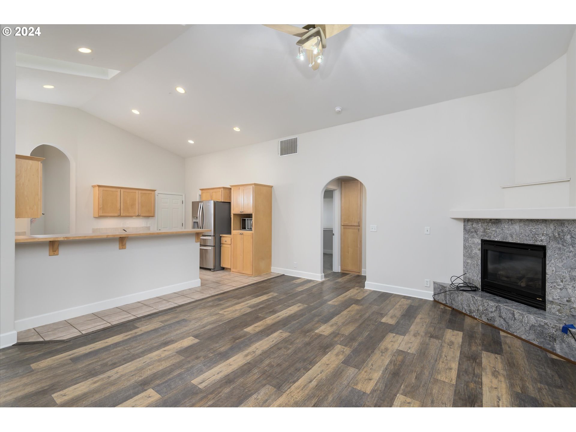654 62nd Street Springfield, OR 97478 - Photo 11 of 41 a view of empty room with wooden floor and fireplace