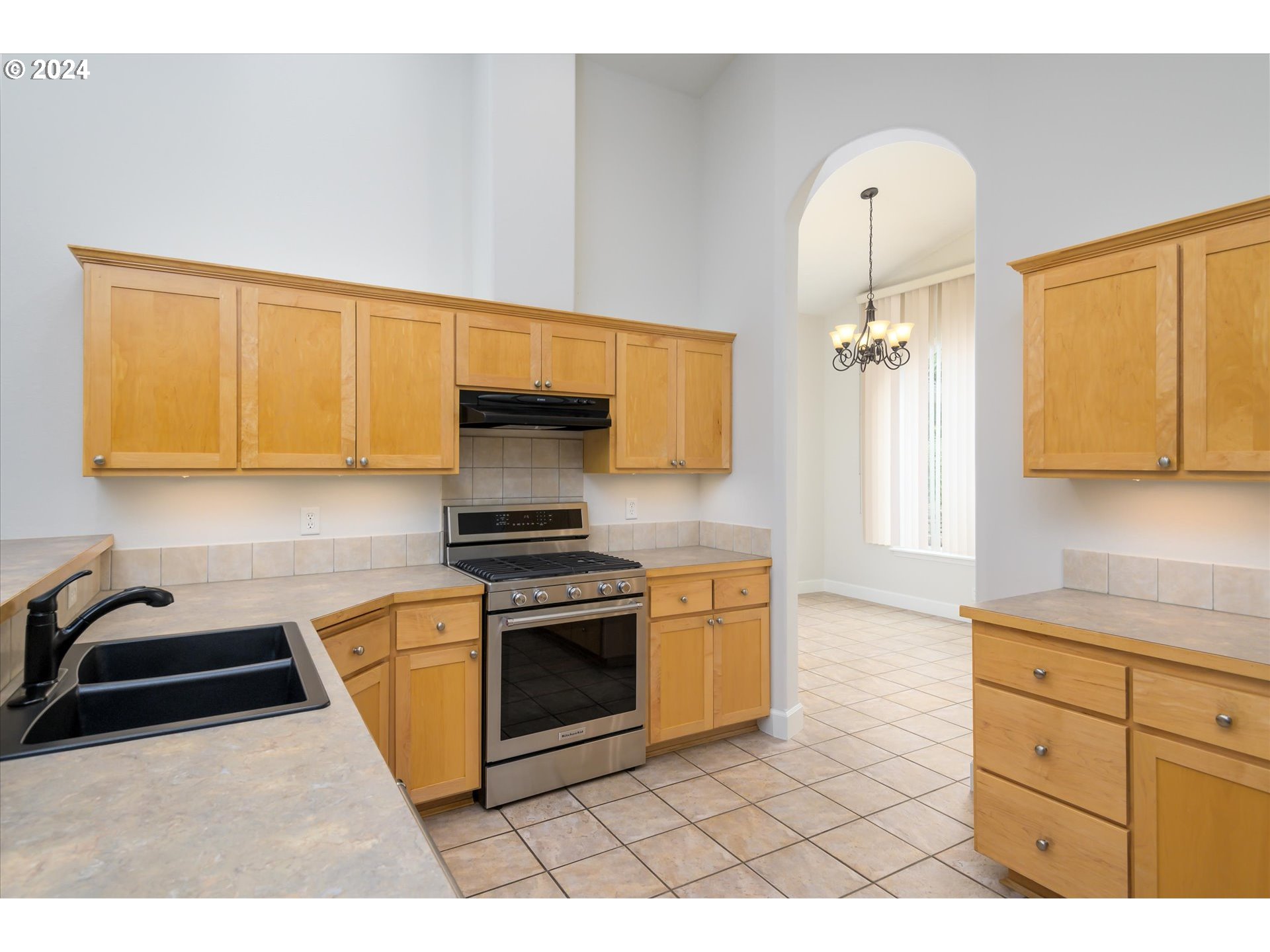 654 62nd Street Springfield, OR 97478 - Photo 14 of 41 a kitchen with stainless steel appliances a sink a stove a microwave and cabinets