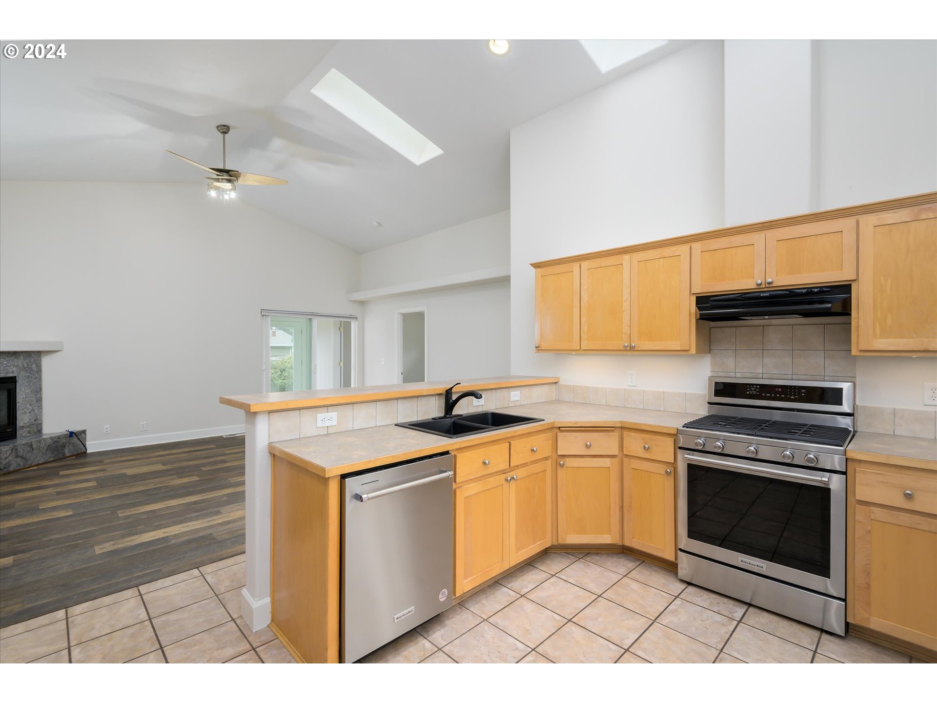 654 62nd Street Springfield, OR 97478 - Photo 15 of 41 a kitchen with stainless steel appliances granite countertop a stove a sink and a microwave