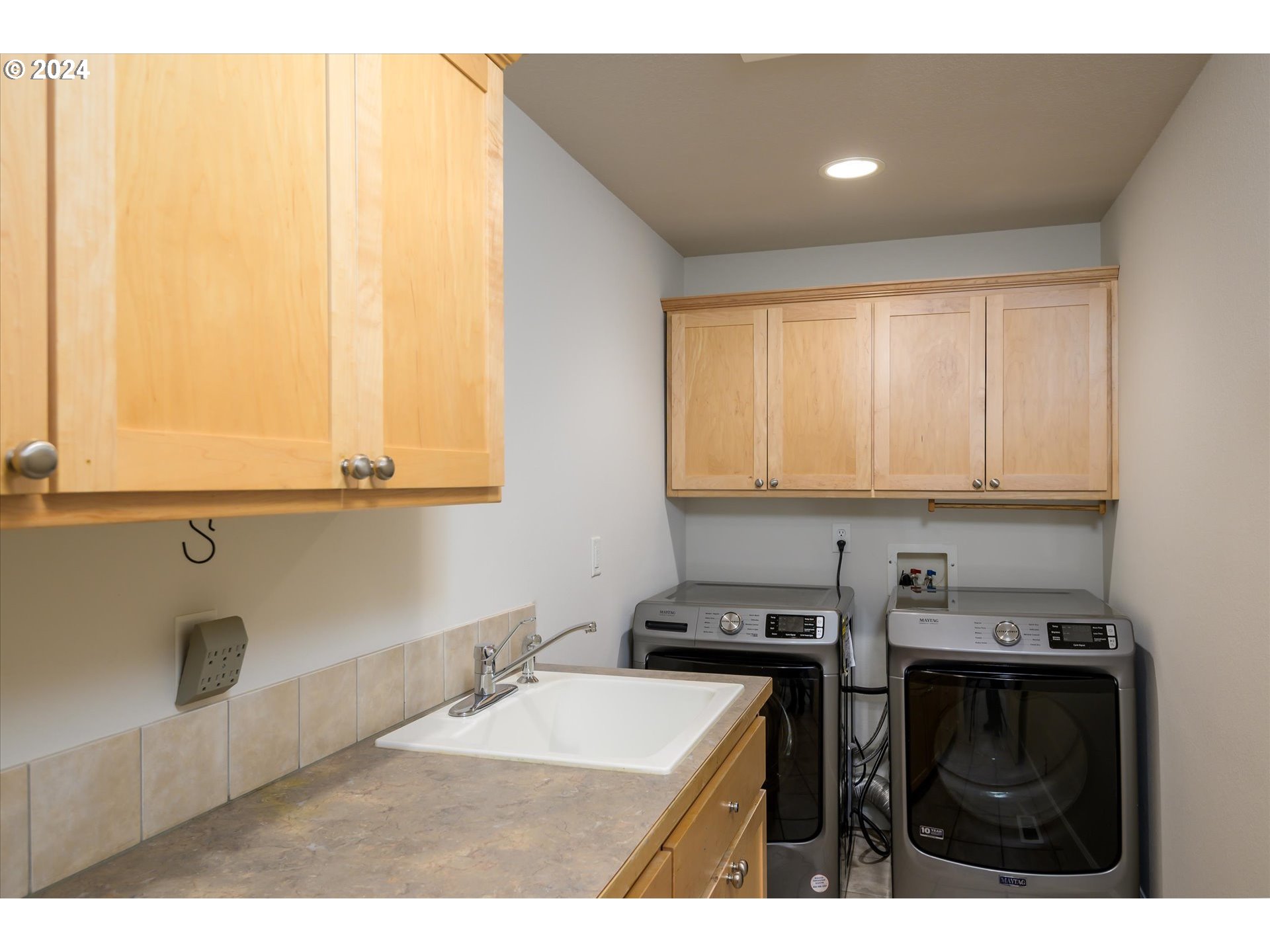 654 62nd Street Springfield, OR 97478 - Photo 17 of 41 a kitchen with kitchen island a sink a stove and a microwave
