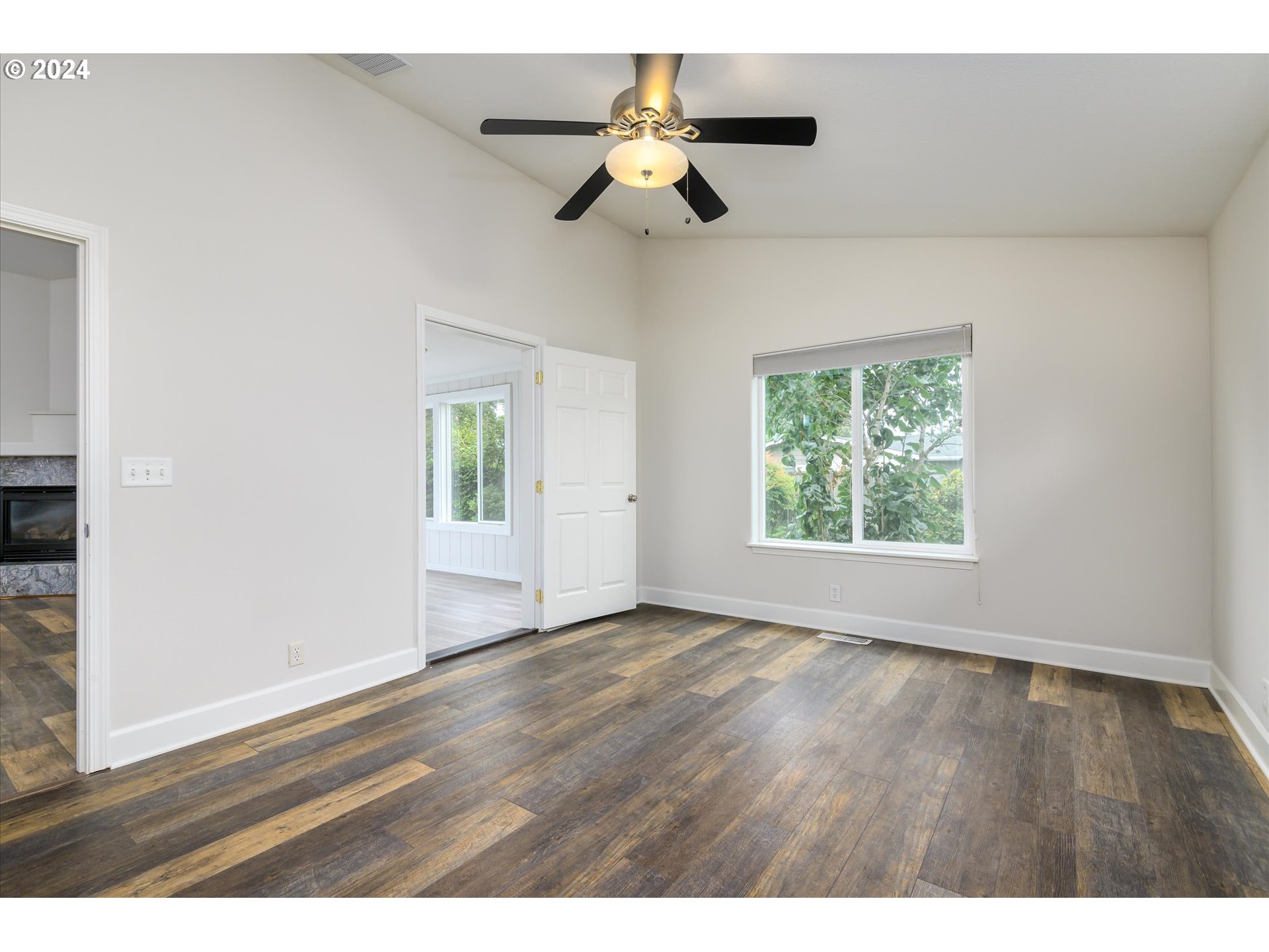 654 62nd Street Springfield, OR 97478 - Photo 21 of 41 a view of an empty room with wooden floor and a window