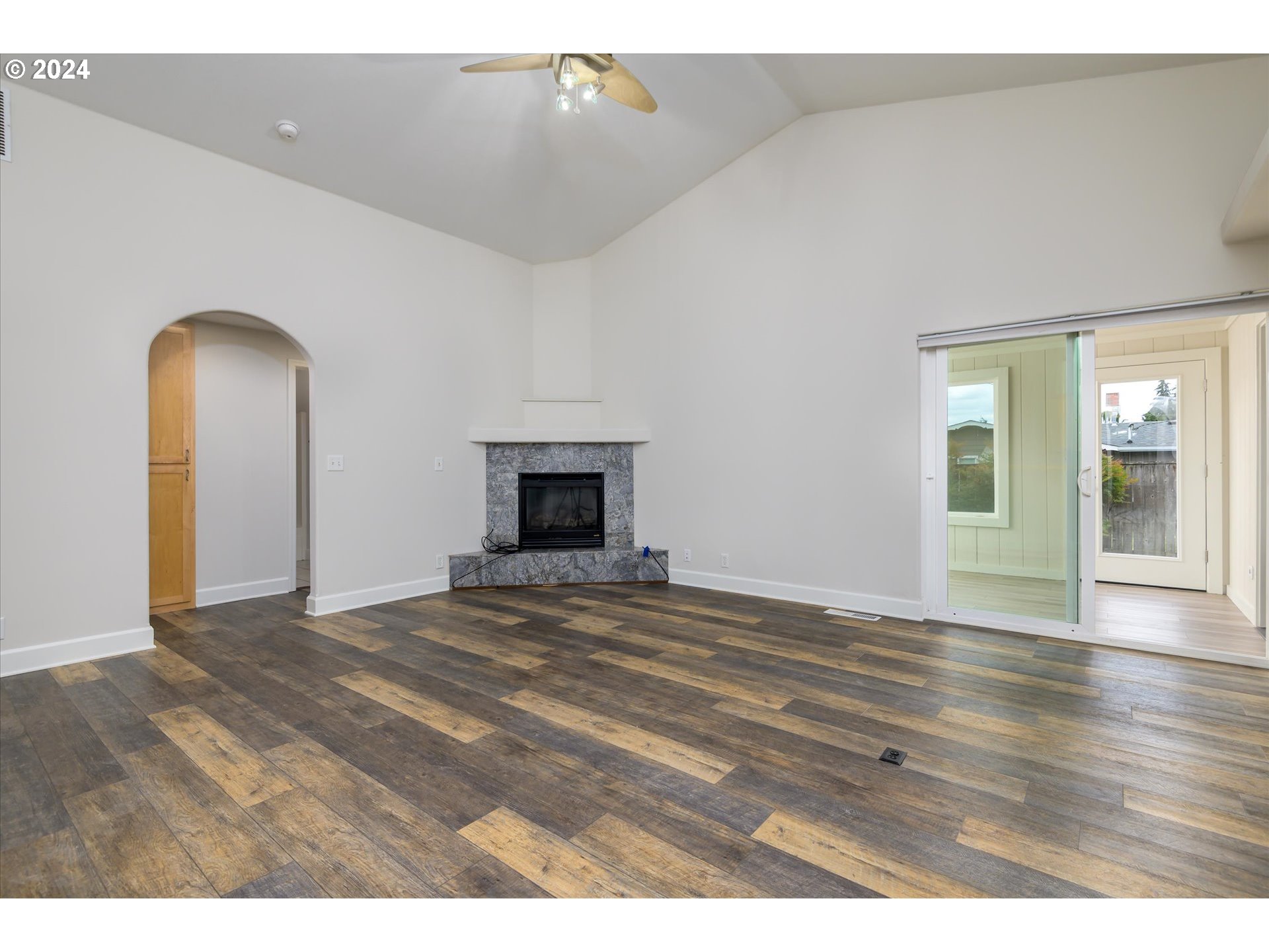 654 62nd Street Springfield, OR 97478 - Photo 10 of 41 a view of empty room with wooden floor and fireplace