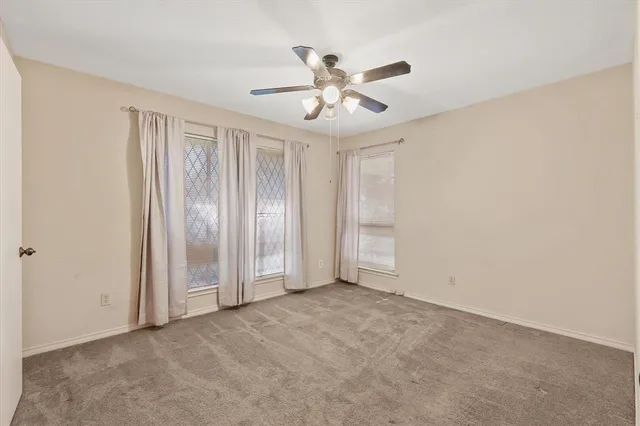 a bathroom with a granite countertop double vanity sink toilet mirror and bathtub
