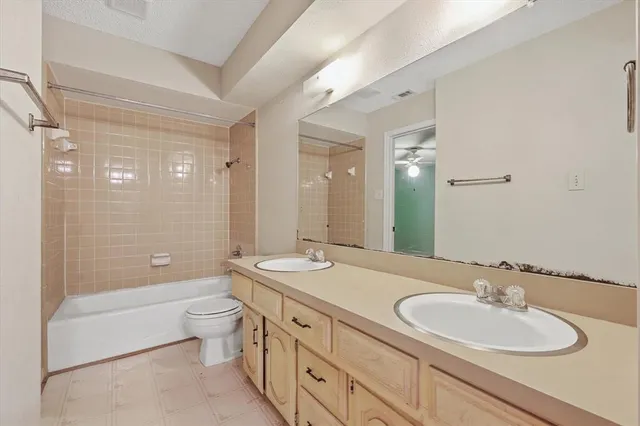 a view of an empty room with a ceiling fan and window